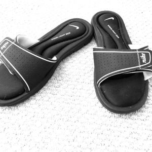 Black & white Nike slides